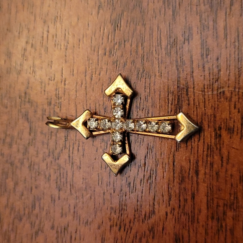 Small gold colored cross necklace without the chain